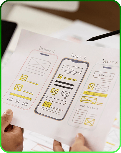 Hand-drawn sketches of mobile app screens on a desk