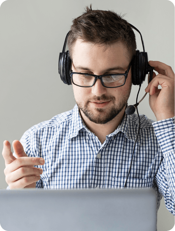 Deskrive Care technical support specialist wearing headphones assisting a client