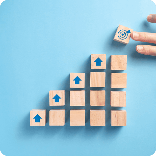 Wooden blocks stacked like a staircase with ascending arrows representing scalable architecture